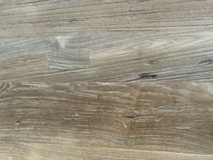 Rustic finishing on solid teak wood furniture with natural texture, distressed look, and handcrafted details.