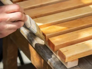 Water-based finishing on solid teak wood furniture providing a smooth, durable, and eco-friendly protective coating.